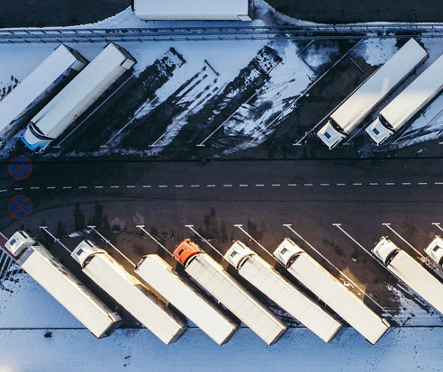 Overhead shot of trucks parked in a parking lot.