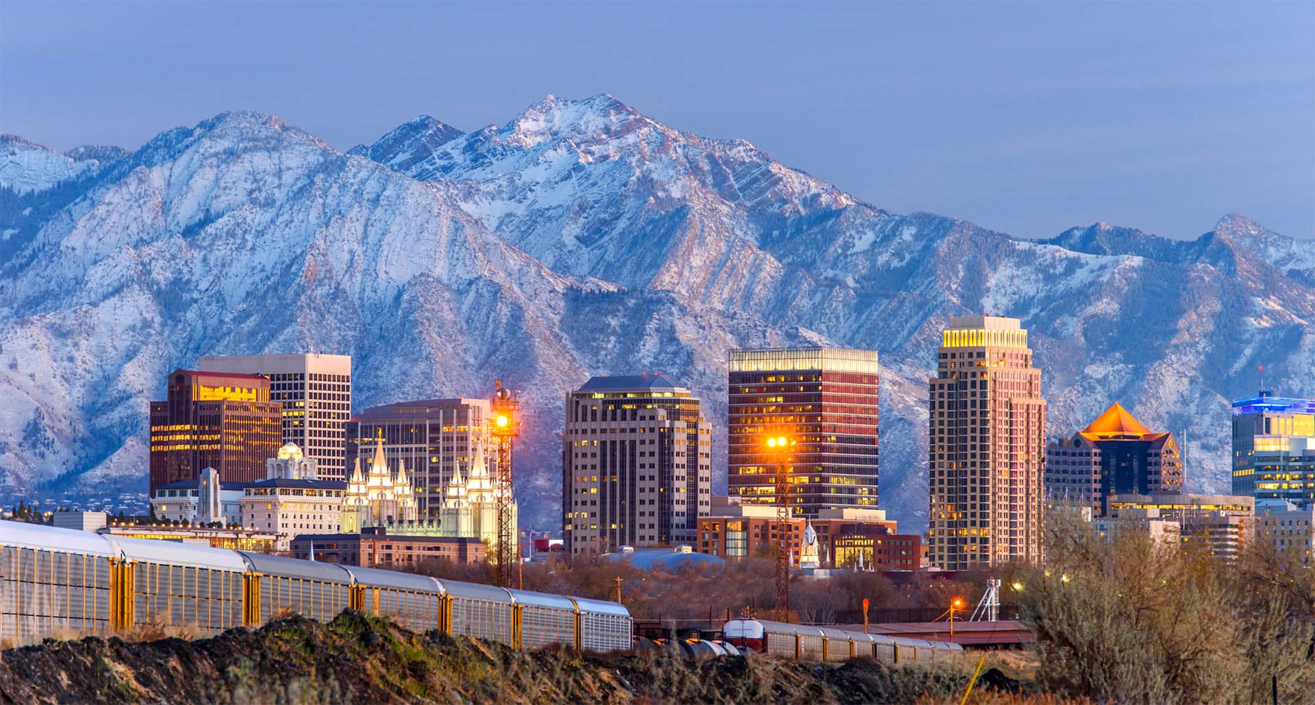 Aerial shot of the Salt Lake City, Utah skyline with mountains in background.